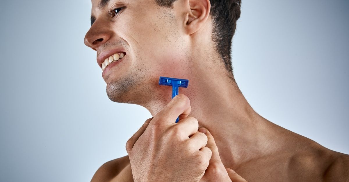 young man in discomfort while shaving