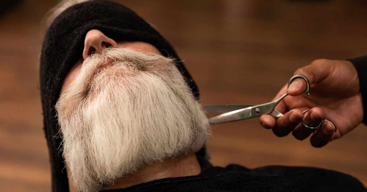 Man's beard being trimmed