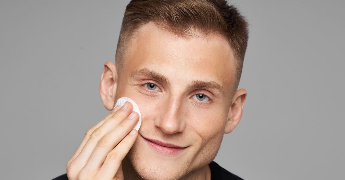 man using facial cleanser