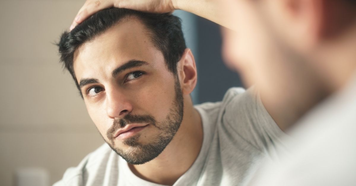 man concerned about stress related hair loss