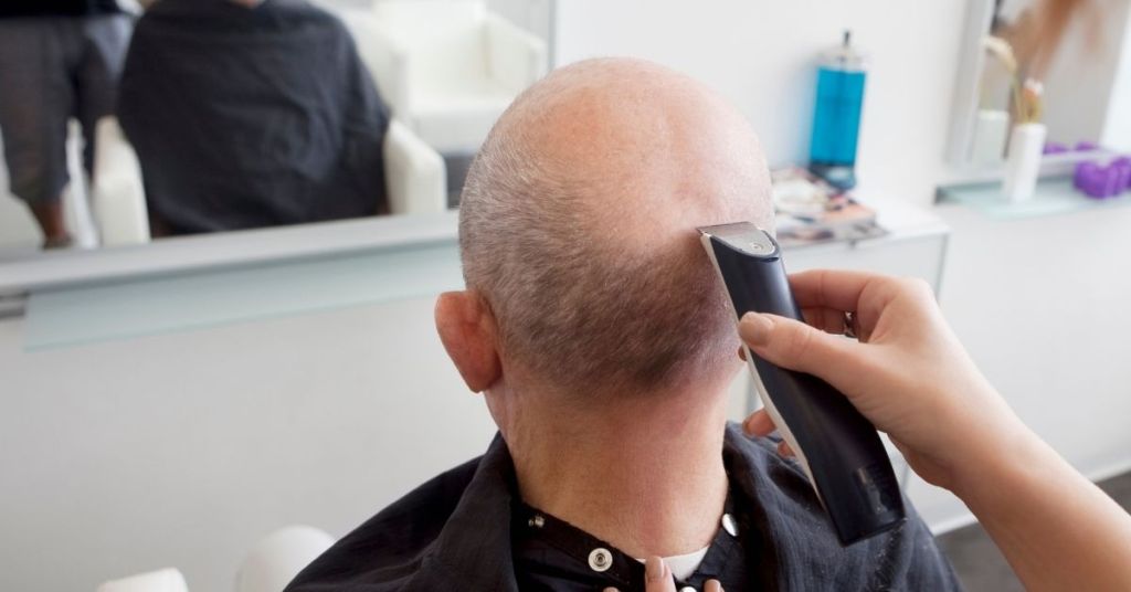 man in the salon using bald clipper