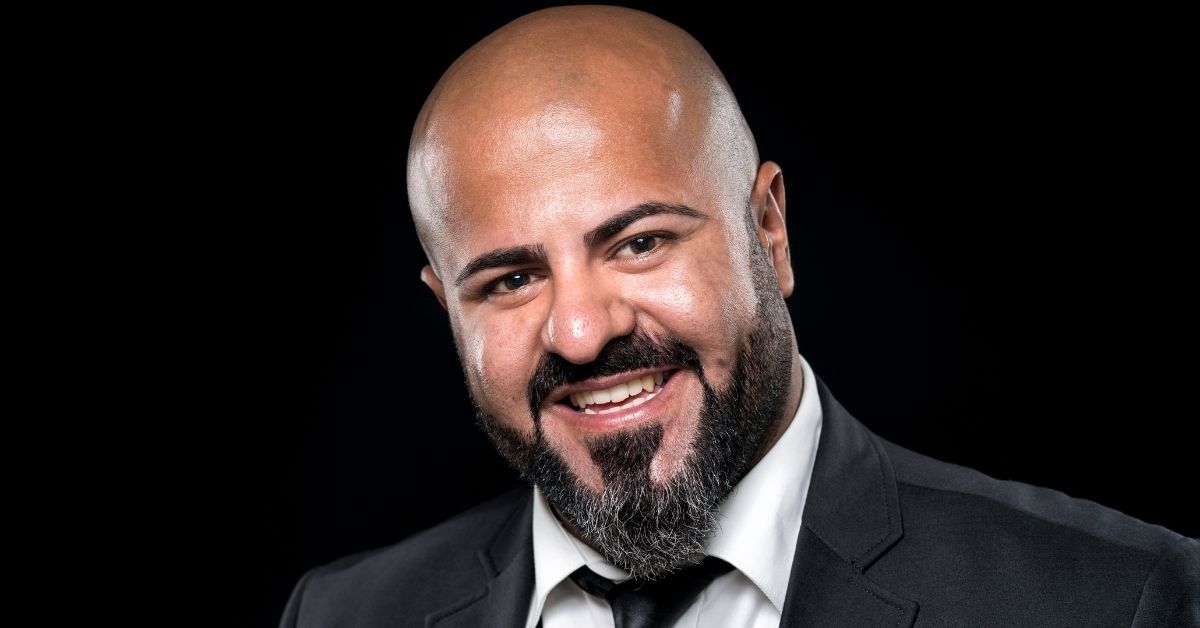 Bearded man with shaved head in business attire