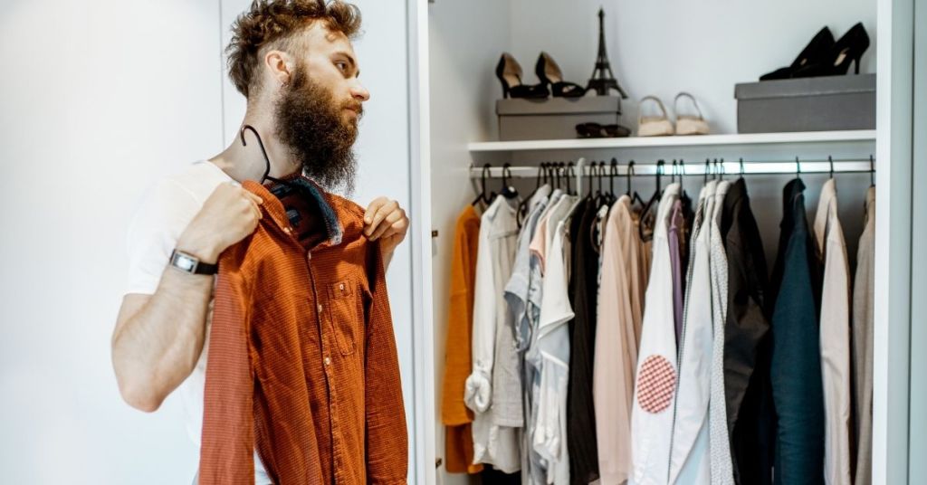 Man looking for right outfit for occasion