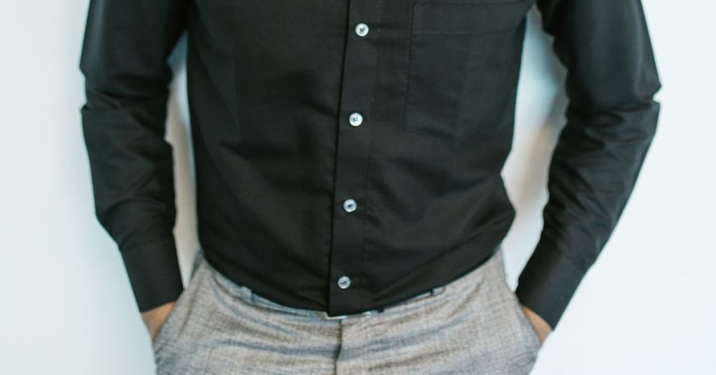 man wearing black dress shirt and tuck in