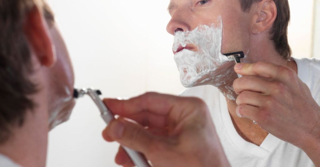 Man shaving in the direction of hair growth